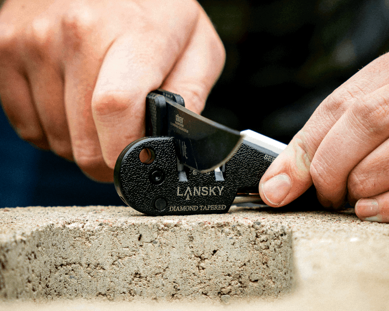 Hand sharpening a knife with a Lansky diamond tapered sharpener